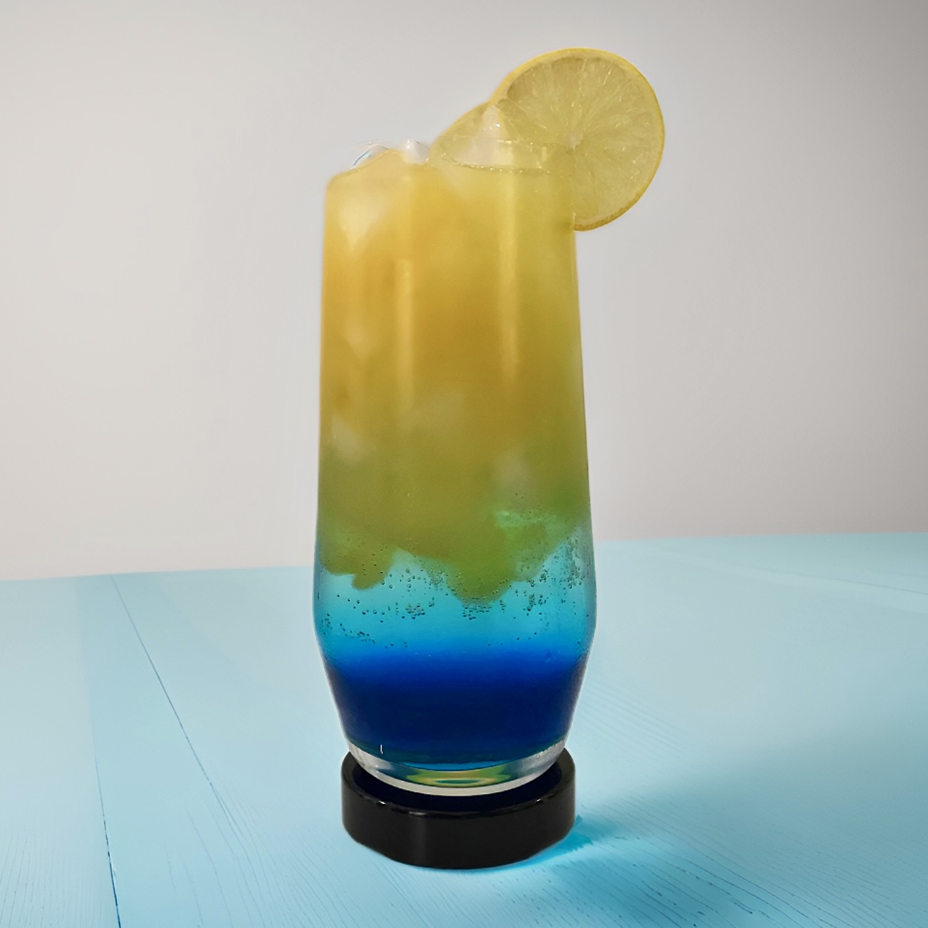 a vibrant blue and yellow green screwdriver mocktail drink in a glass